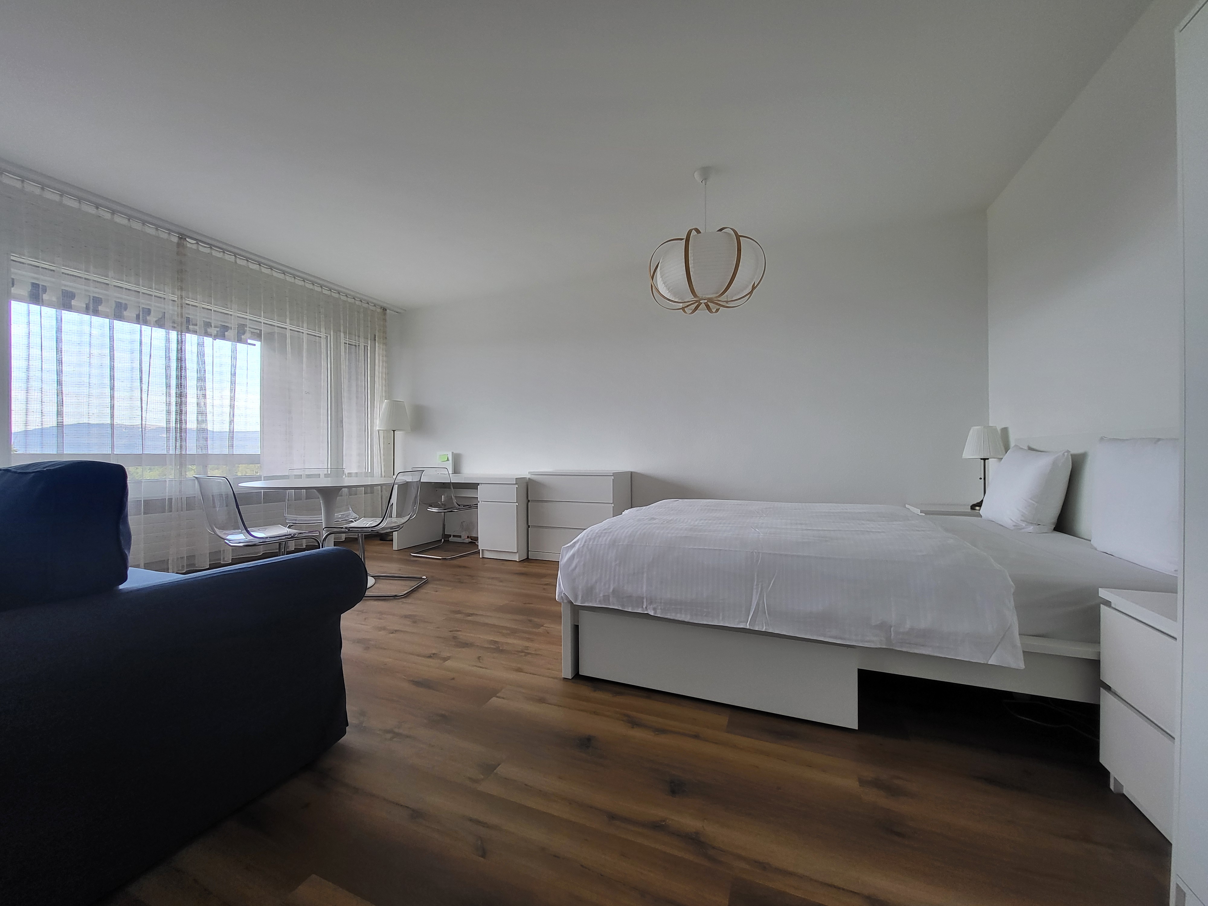 Image of the apartment's living room and bedroom, with its new cosy furniture