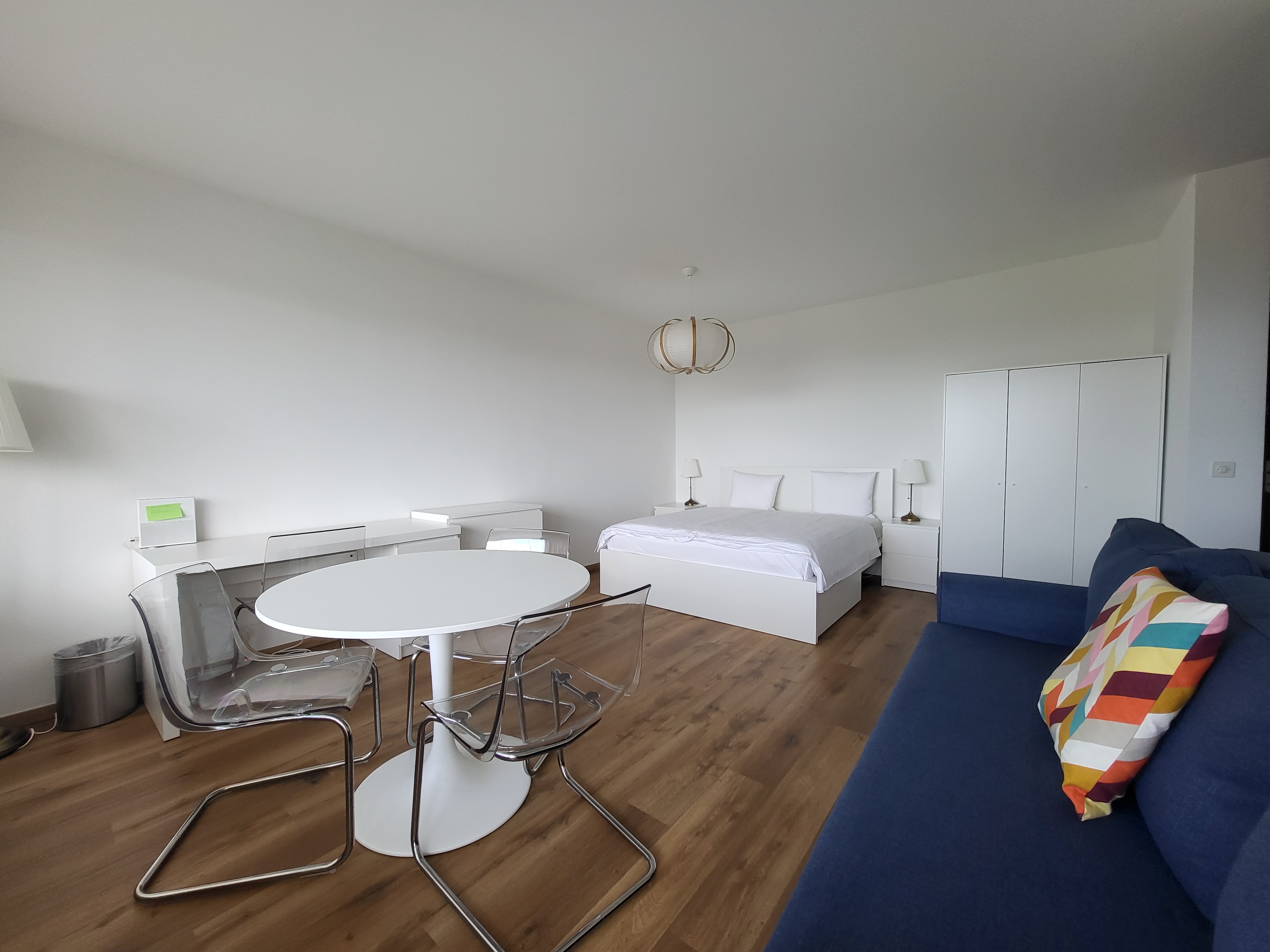 Image of the apartment's living room and bedroom, with its new cosy furniture